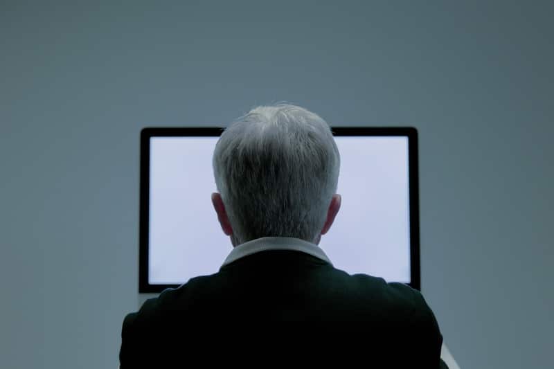 middle-aged man in front of an online filing platform